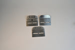 Load image into Gallery viewer, Three metal brackets on a light gray background
