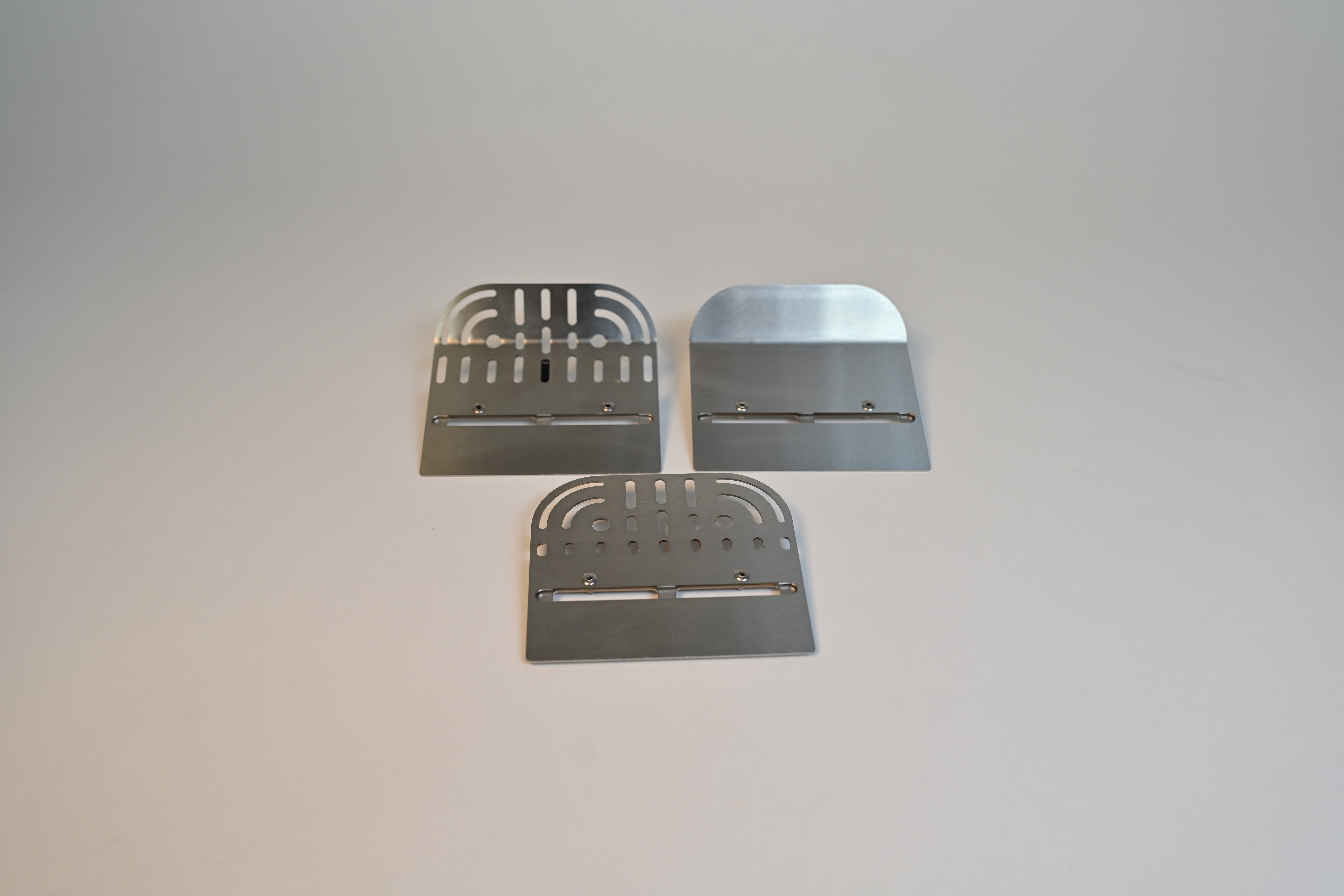 Three metal blades on a gray background