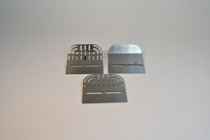 Three metal blades on a gray background